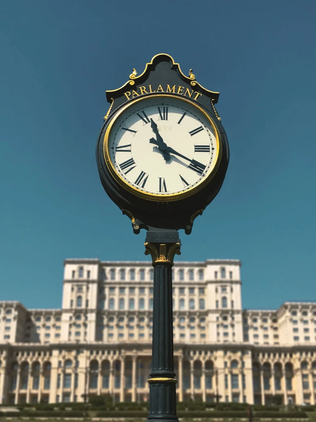 Ornate Parliament street clock against a blue sky